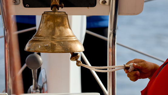 a column on the nose of the yacht in which the child's hand rings. High quality photo