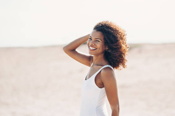 istock Smiling young African ethnicity woman walking outdoors at sunlight 1284970947