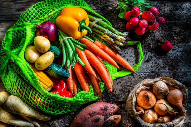 istock Fresh organic vegetables in a green mesh shopping bag. Copy space 1284970962