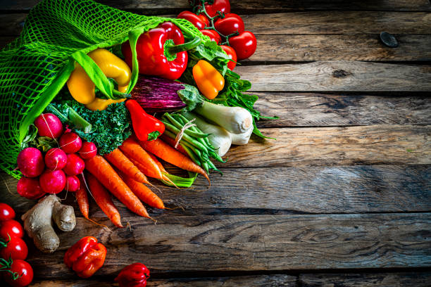 istock Fresh organic vegetables in a green mesh shopping bag. Copy space 1284971733
