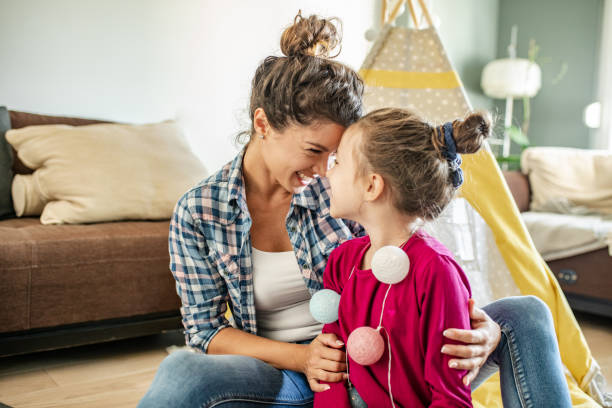 istock Playful mother and daughter at home 1284971913