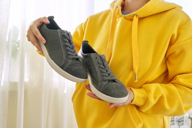 New men's leather gray sneakers in hands