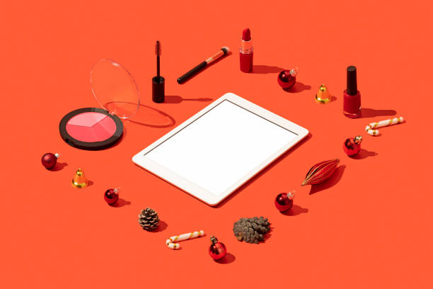 istock Christmas concept flat lay with digital tablet mockup, template and cosmetics on red background 1284971967