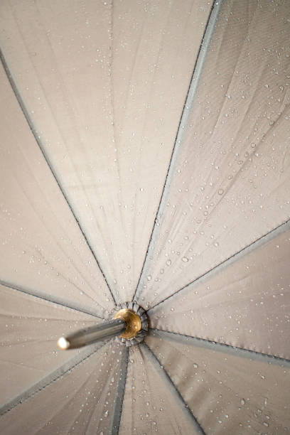 зонт центр с каплями дождя на нем - cold rain parasol gray стоковые фото и изображения