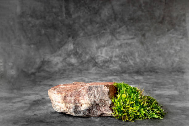 istock Natural stone stand for presentation and exhibitions on dark background. Abstract podium for organic cosmetic products. Minimal style. 1284972926