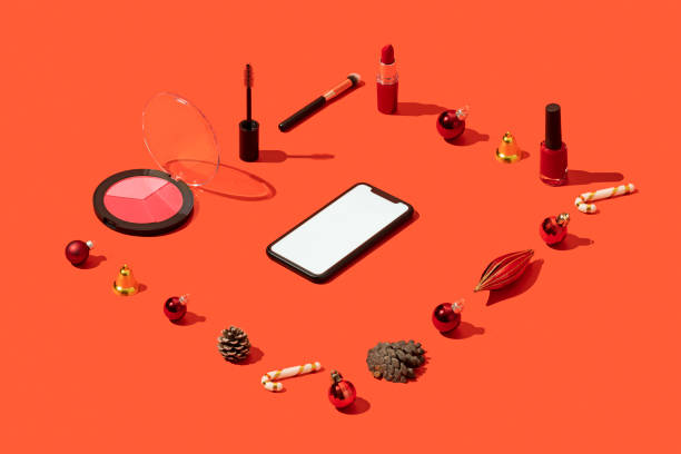 クリスマスコンセプトフラットは、赤い背景にスマートフォンのモックアップ、テンプレートや化粧品と横たわって
