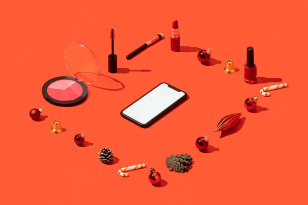 istock Christmas concept flat lay with smart phone mockup, template and cosmetics on red background 1284973250