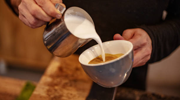 istock Close-up milk is added to the coffee in the coffee cup. 1284978085