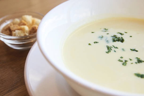 istock Delicious cheese soup. Small crackers. White dishes 1284978214