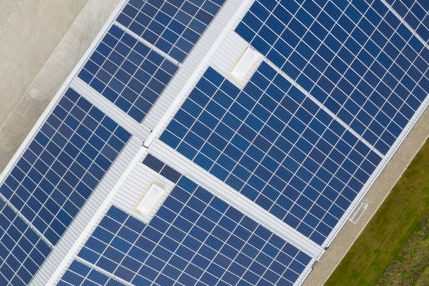 istock Solar Panels Gathering Sunlight on Rooftop, Industrial Building, Aerial View 1284980376