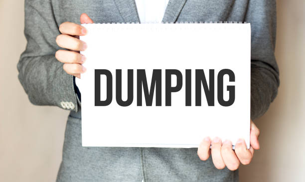 istock businessman holding a card with text DUMPING 1284981736