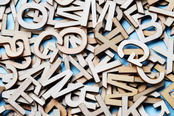 istock Mixed wooden letters close-up on a blue background 1284983003
