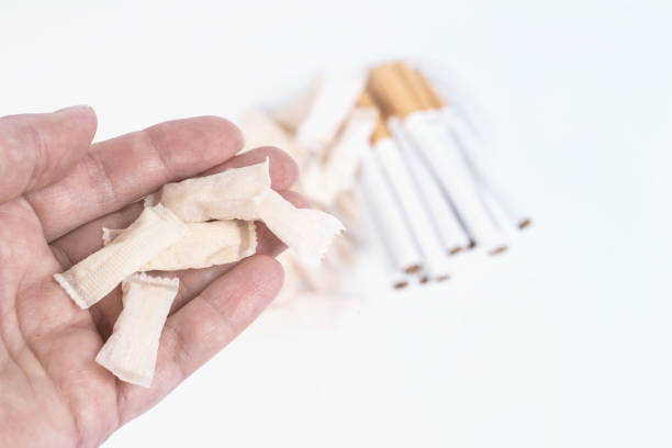 the choice of nicotine between snus and cigarettes - snuff box imagens e fotografias de stock