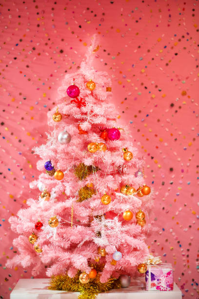 istock Pink christmas tree on pink background 1284984063