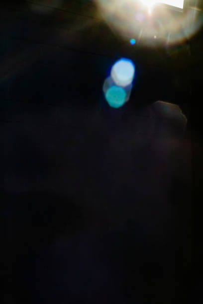 istock a light leak flare on a solid black background with colorful bokeh 1284984527