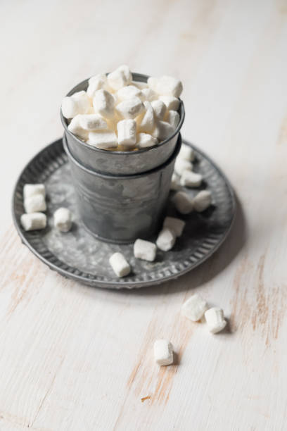 A bowl of white marshmallows stock photo