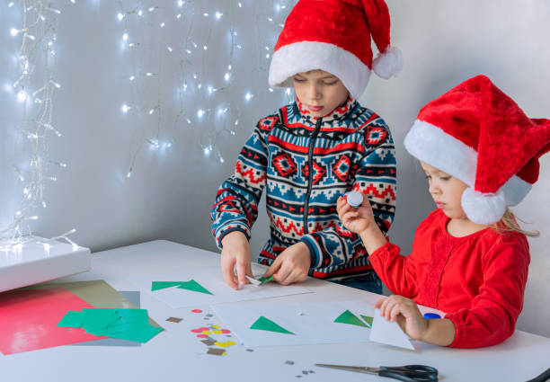 istock Brother and sister make Christmas card. 1284985379