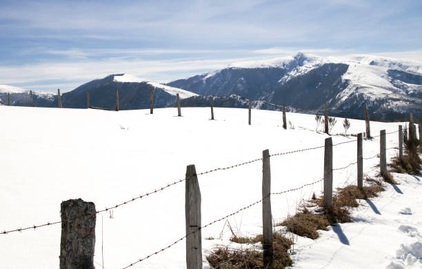 istock Snowy landscape with a fence in the foreground 1284985467