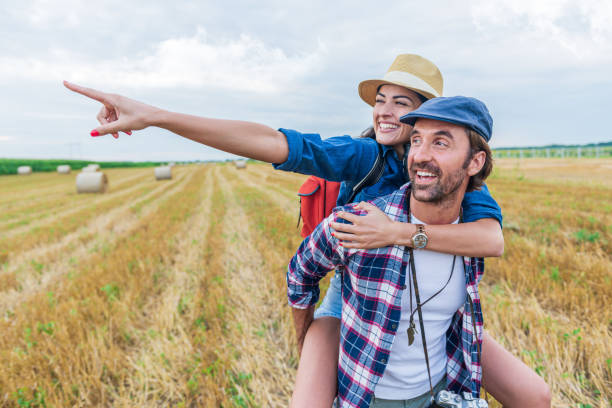 istock Young cheerful couple in a field 1284987618