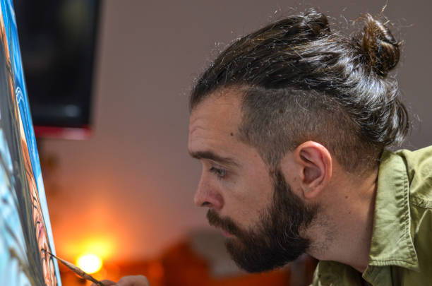 istock Male artist painting with artificial light 1284989001