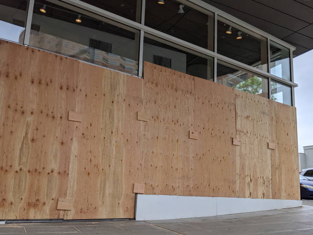 istock boarded up windows and doors in a downtown building during protests and riots 1284990883