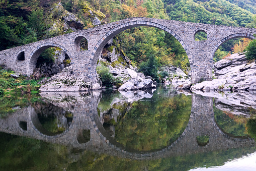 Devil's bridge is three-arched bridge over the Arda River in a narrow gorge  part of an ancient road system, Bulgaria.