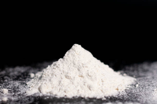 istock A mound of white flour on a dark surface. Side view. 1284995410