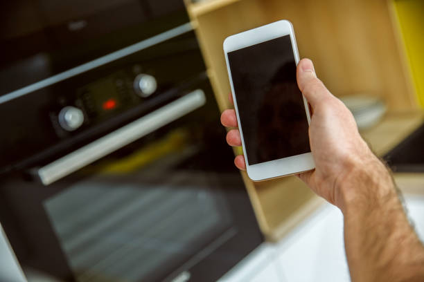istock Bachelor man daily routine in the kitchen single lifestyle concept with phone close-up 1284999044