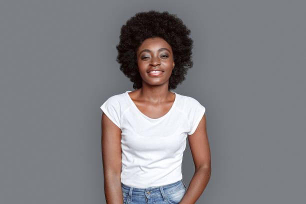 istock Young woman standing isolated on gray looking camera relaxed 1284999076