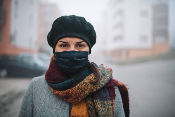 portrait of young woman with protective face mask outdoor.