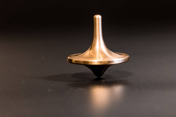 istock Die Cast Spinning Top Silhouetted with gold color 1285000547
