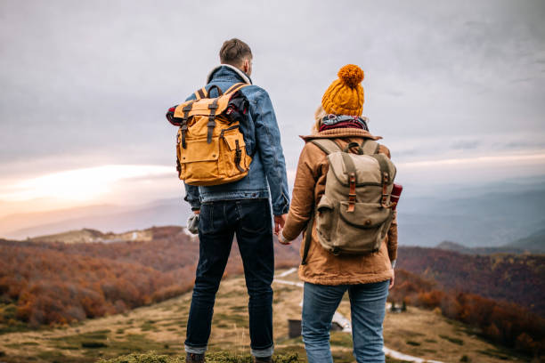 istock Romantic young couple on the mountain peak 1285001539