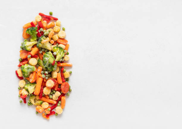 istock Frozen vegetables mix on a white background. Sliced frozen vegetable salad. View from above. Copy space. 1285001689