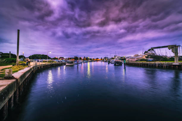Fisherman fishing at Mordialloc Pier in Victoria-Australia, during twilight and sun rise hours.