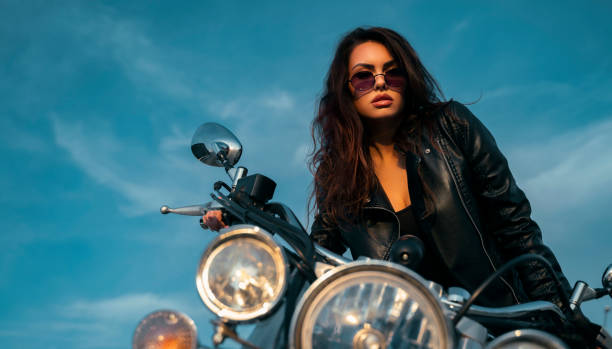 istock Attractive, sexy brunette posing on motorcycle 1285011431