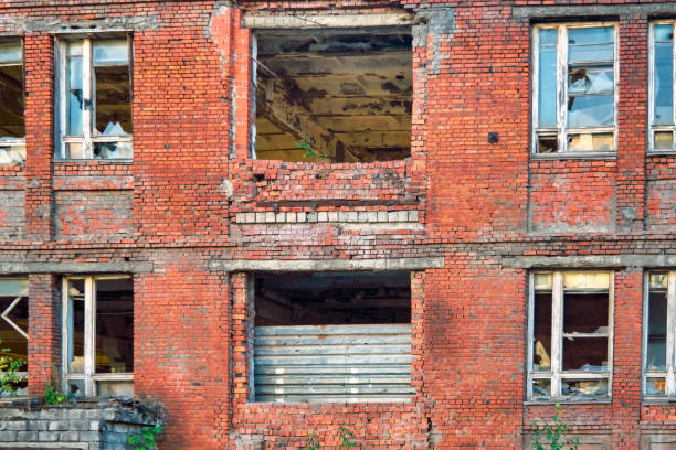 istock A fragment of an old abandoned red brick building with broken windows. 1285012225
