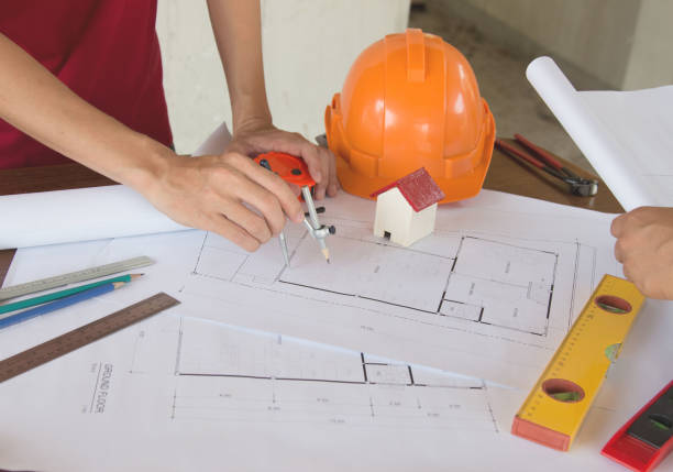istock team Engineer and Architect consult projct with blueprint  at Construction Site 1285012330