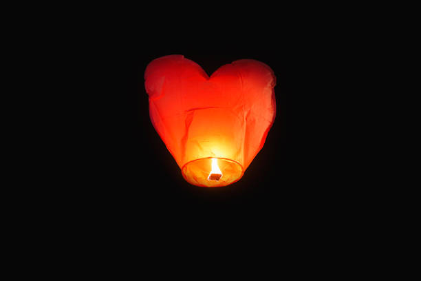 istock Heart shaped lamp flying with candlelight in the sky, concept love 1285013142