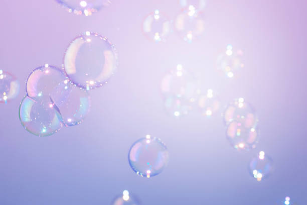 istock Beautiful transparent shiny soap bubbles flot on purple texture background. Abstract, Natural fresh soapy summer background. 1285015840