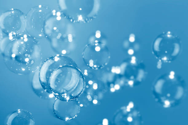 istock Beautiful shiny transparent soap bubbles float on dark blue background. Abstract, Natual fresh summer a blue texture. 1285015844