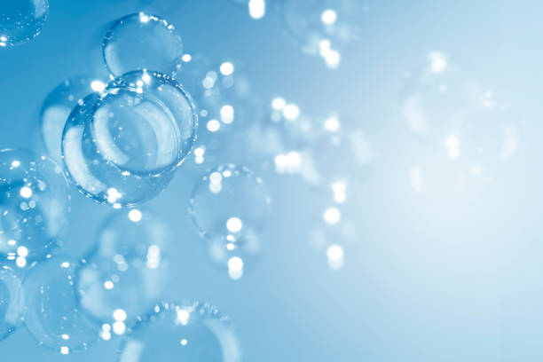 istock Beautiful shiny transparent soap bubbles float on a blue background. Abstract, Natual fresh summer a blue texture with copy space. 1285015847