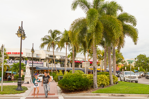 September 20, 2020 - Siesta Beach, Sarasota, Florida, United States of America USA: A general landscape view of North Quadrant of St. Armands Circle town square, with people enjoying a warm afternoon taking a short walk around the bars, restaurants, pubs, stores and much more, in a cloudy raining summer sunset day.\n\nSt. Armands Circle is 5 minutes from Sarasota downtown, and half hour from Siesta Beach, one of the most famous beaches around United States. Also, just two hours driving from Atlanta and four hours driving from Miami.\n\nPhoto taken during the Corona Virus Pandemic illness in a cloudy summer sunset day.