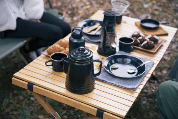 image photo of women having lunch at a campsite - group of objects travel friendship women imagens e fotografias de stock