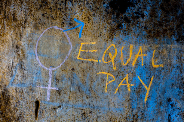 istock Creative representation of Equal pay with a bigender symbol over a rough wall with written Equal pay. 1285023834