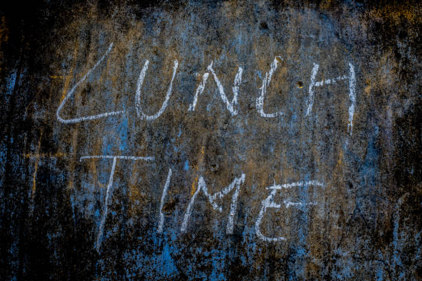 istock Lunch Time wrote on rough texture wall with white-colored chalk, horizontal shot. 1285023842