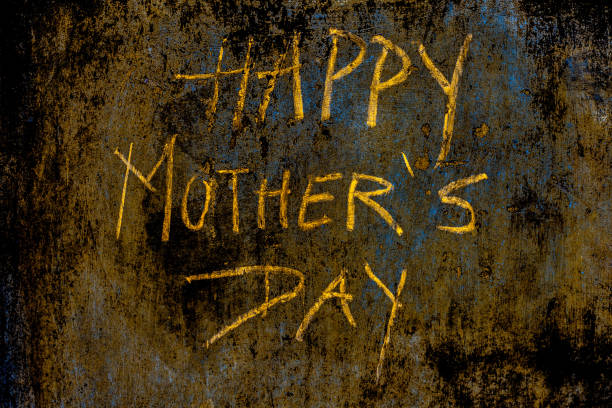 istock Happy Mother's Day written on a rough wall with yellow-colored chalk. 1285023845