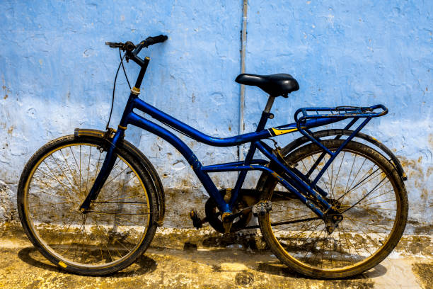 istock Blue colored bicycle isolated against the blue wall. 1285023991