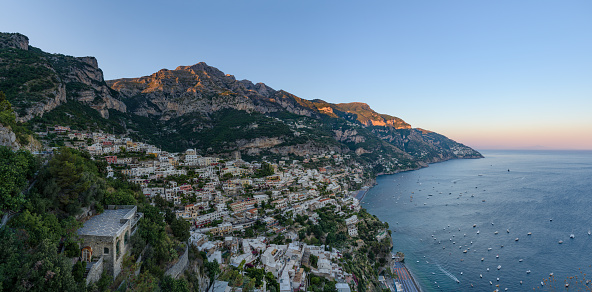 Panoramic view of Amalfi Coast, with Positano seaside village and beach, leisure boats moored in a bay and scenic cliffs from famous hiking path of the Gods in Campany, Italy