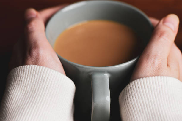 istock Woman holding hot cocoa or coffee mug 1285025033