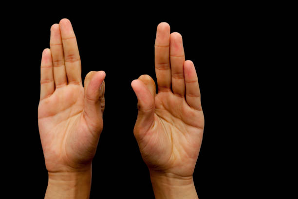 istock Hands in Vayu Mudra isolated on a black background. 1285025762